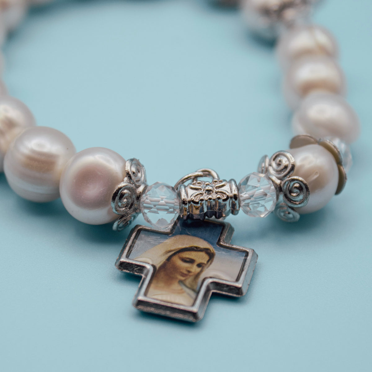 Blessed Mother devotional cross on pearl-style rosary bracelet