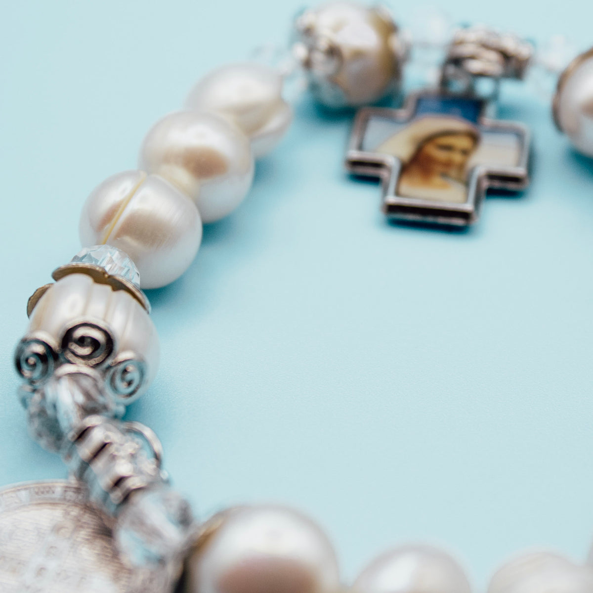 Blessed Mother devotional cross on pearl-style rosary bracelet