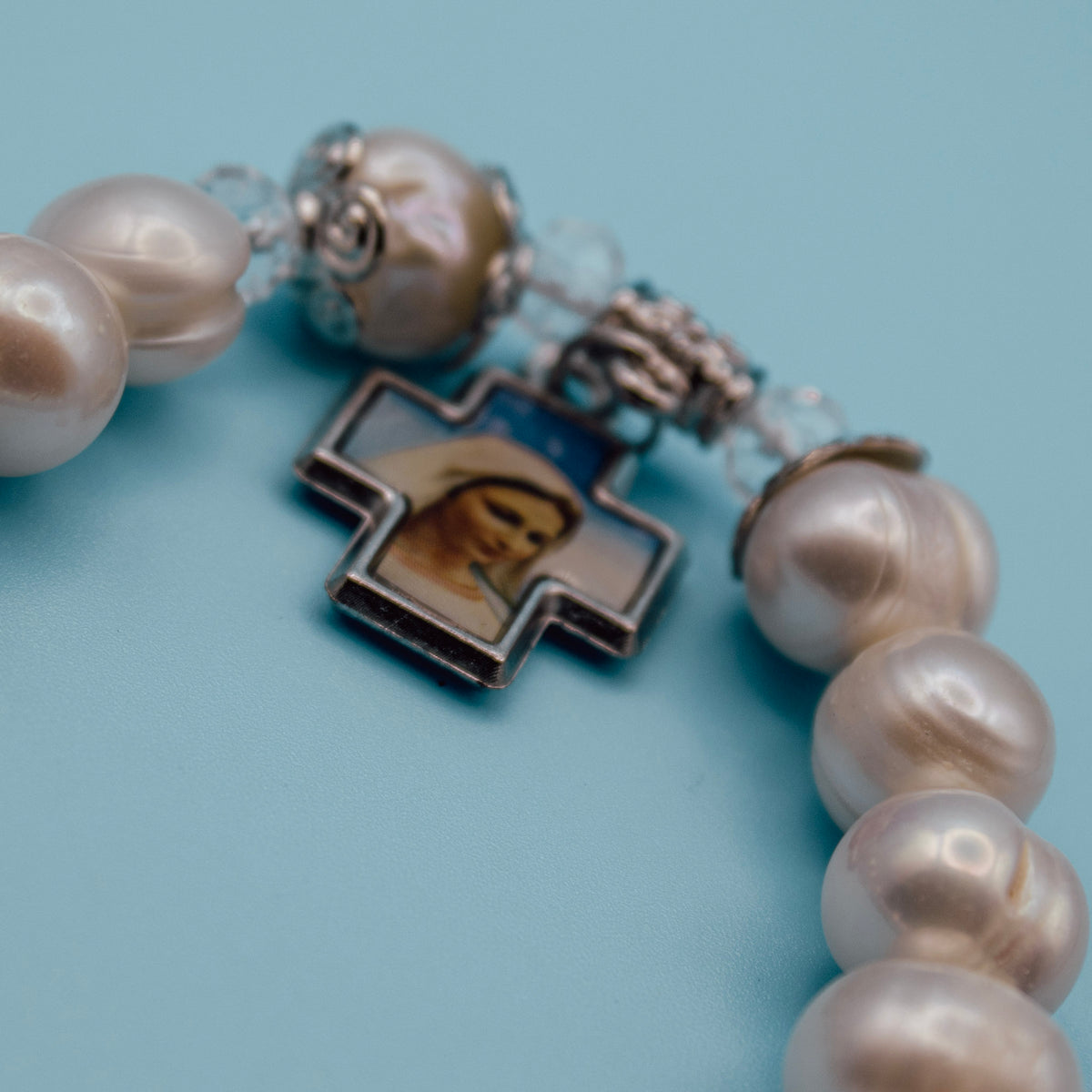 Blessed Mother devotional cross on pearl-style rosary bracelet
