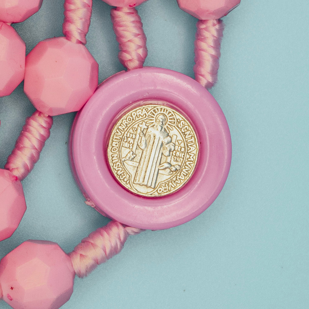 Saint Benedict Medal centerpiece with pink faceted Rosary beads